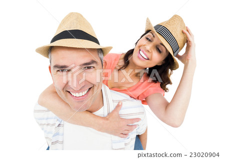 Handsome man piggy backing his wife Handsome man piggy backing his wife 23020904