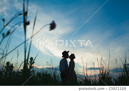Young couple in love in the meadow 23021189