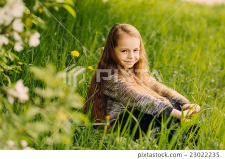 Portrait of little cute beautiful girl in garden Portrait of little cute beautiful girl in garden 23022235
