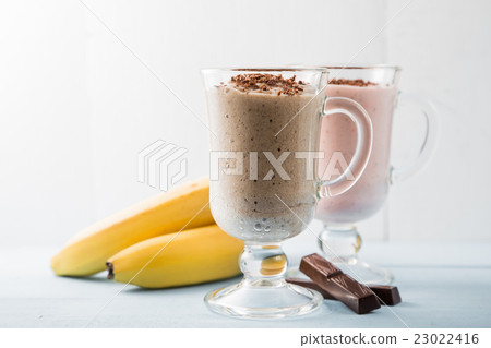 Two smoothies of chocolate, bananas and strawberry 23022416