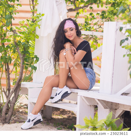 Beautiful young woman outdoor portrait 23023611