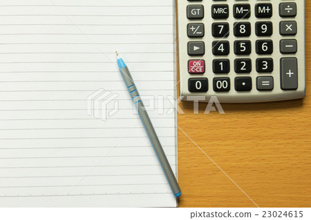 Paper note with blue pen, calculator 23024615