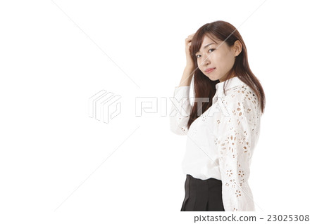 Young lady touching hair Young lady touching hair 23025308
