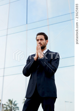 Confident male lawyer is standing outdoors Confident male lawyer is standing outdoors 23025693