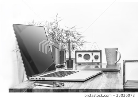 laptop on wooden desk black and white color 23026078