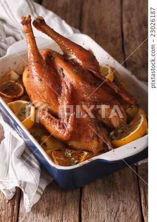 Homemade lemon chicken with herbs baked closeup Homemade lemon chicken with herbs baked closeup 23026187