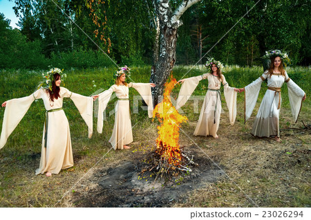Beautiful women with flower wreath near bonfire 23026294