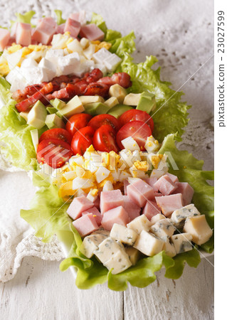 Tasty American Cobb salad close-up on a plate 23027599