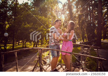 couple kissing stand bridge on background forest 23028150