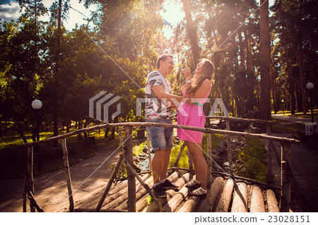 couple kissing stand bridge on background forest couple kissing stand bridge on background forest 23028151