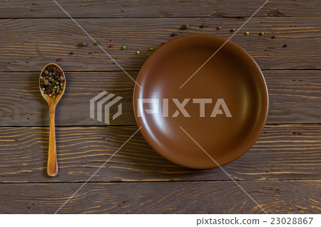 Wooden Spoon With Colored Pepper Lies On The Board 23028867