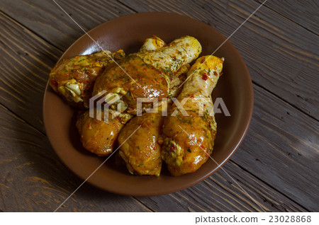 Raw Chicken Legs With Spices Lie On A Platter Raw Chicken Legs With Spices Lie On A Platter 23028868