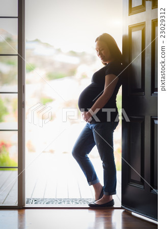 Chinese Pregnant Woman Standing in Doorway Chinese Pregnant Woman Standing in Doorway 23029312