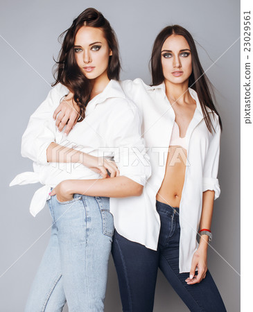 two sisters twins posing, making photo selfie 23029561