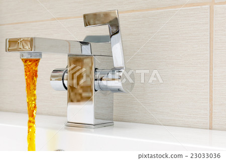 Chromium-plate tap with rusty, dirty  water. 23033036