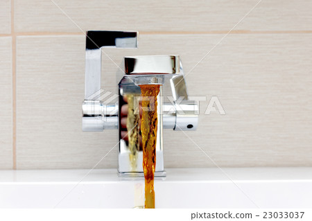 Chromium-plate tap with rusty, dirty water. Chromium-plate tap with rusty, dirty water. 23033037