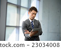 3 30-year businessman standing at the window of an inorganic office 23034008