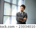 3 30-year businessman standing at the window of an inorganic office 23034010