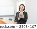 A woman in her twenties standing with a tablet in the office car 23034107