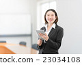 A woman in her twenties standing with a tablet in the office car 23034108