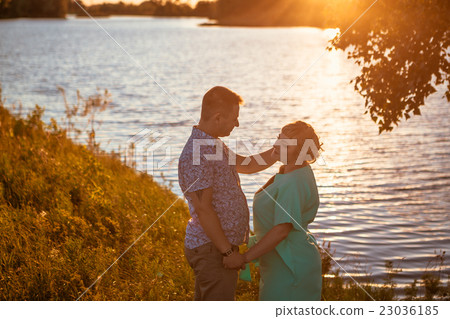 Romantic couple kissing on background lake sunset Romantic couple kissing on background lake sunset 23036185