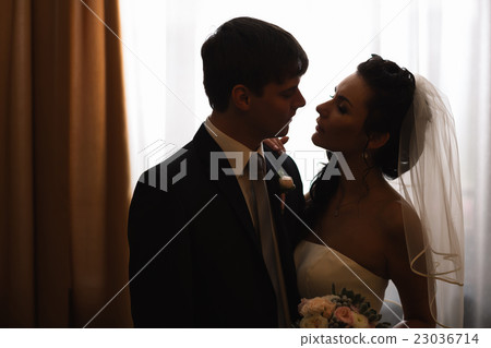 beautiful young couple standing near the window beautiful young couple standing near the window 23036714