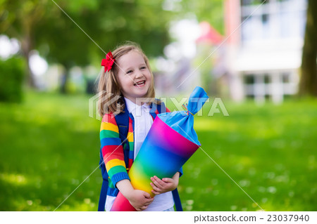 Little child with candy cone on first school day Little child with candy cone on first school day 23037940