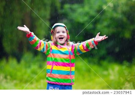 Child playing in the rain Child playing in the rain 23037941