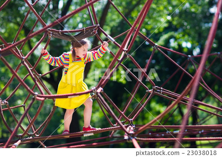 Child having fun on school yard playground Child having fun on school yard playground 23038018