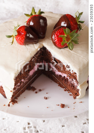 chocolate cake with white icing and strawberries 23039393