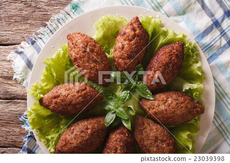Arabic beef meatballs kibbeh close-up on a plate Arabic beef meatballs kibbeh close-up on a plate 23039398