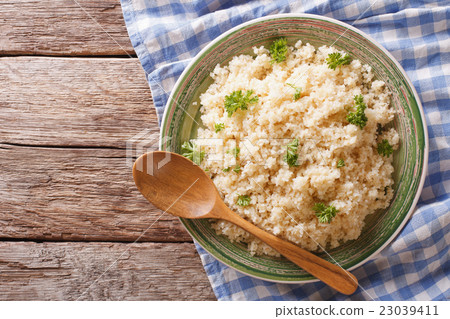 steamed bulgur with parsley close-up on a plate steamed bulgur with parsley close-up on a plate 23039411