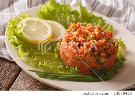Turkish appetizer spicy k?s?r of bulgur with herbs 23039430