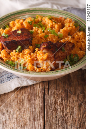Spicy bulgur with beef close-up on a plate 23042577
