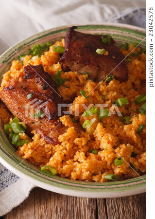 Asian bulgur pilaf with meat close up on a plate 23042578