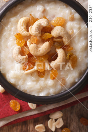 sweet rice pudding with nuts and raisins in a bowl 23042584