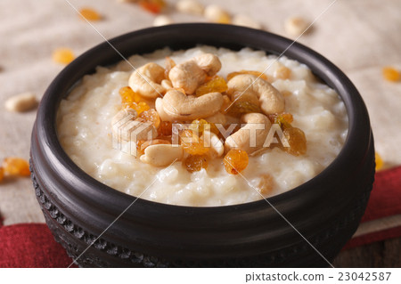 sweet rice pudding with nuts and raisins in a bowl sweet rice pudding with nuts and raisins in a bowl 23042587