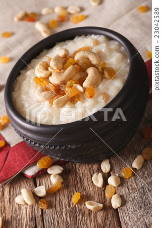 sweet rice pudding with nuts and raisins in a bowl sweet rice pudding with nuts and raisins in a bowl 23042589
