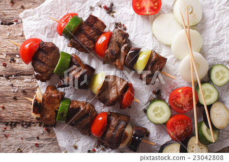 Delicious kebab with vegetables on skewers Delicious kebab with vegetables on skewers 23042808