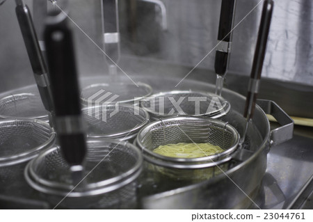 Boiling ramen in the kitchen 23044761