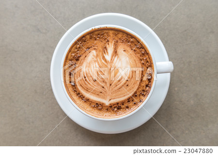 Cup of art latte on a cappuccino coffee 23047880