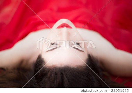 Lady in Red Dress Laying Down Eyes Closed Relaxed Sleeping 23051925