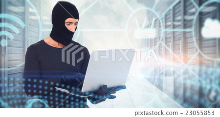 Composite image of burglar with balaclava hacking a laptop 23055853