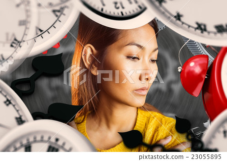 Composite image of serious asian woman looking down Composite image of serious asian woman looking down 23055895