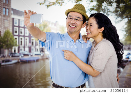 Composite image of man and woman taking a picture Composite image of man and woman taking a picture 23056114