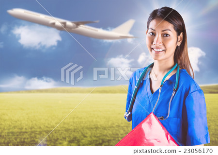 Composite image of asian nurse with stethoscope looking at the c 23056170