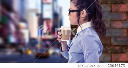 Composite image of businesswoman holding disposable cup and look 23056175