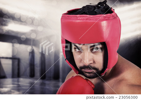 Composite image of muscular man boxing in gloves 23056300