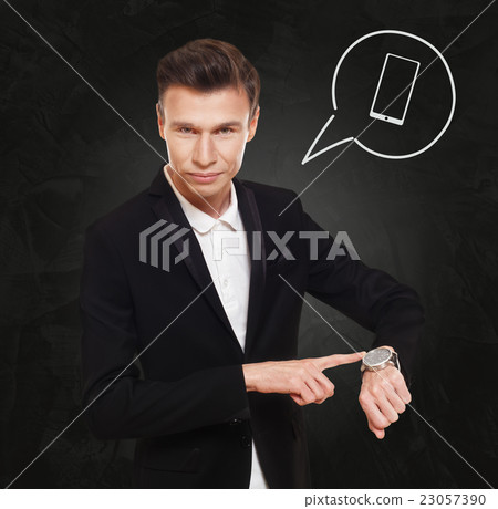 Businessman points at watch, time to call Businessman points at watch, time to call 23057390