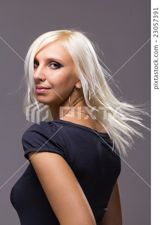 Closeup portrait of dreamy woman isolated on gray Closeup portrait of dreamy woman isolated on gray 23057391